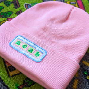 Product photo of a pink ACAB Beanie spelled out with baby blocks.
